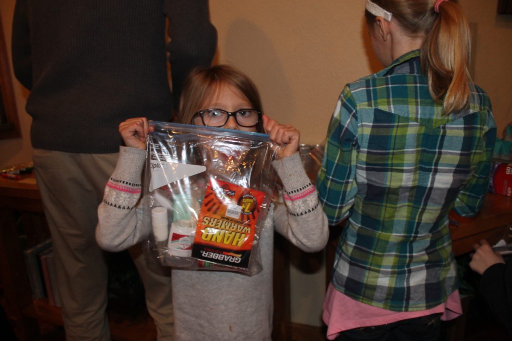 My lovely little niece with one of the care packages we put together. Each had toiletries, granola bar, V-8, pair of socks, beef jerky, hand warmers and a $5 McDonalds gift card.
